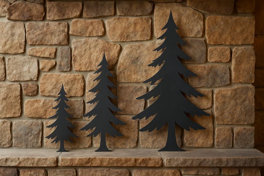 Three metal pine tree wall art pieces in varying sizes arranged on a stone fireplace, adding woodland charm.